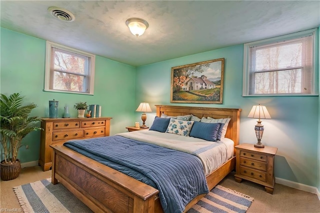 carpeted bedroom featuring multiple windows