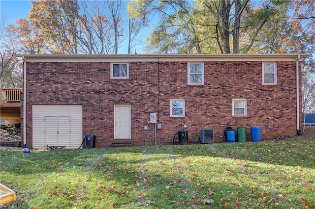 exterior space featuring a lawn and central AC unit