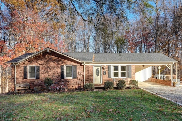 ranch-style house featuring a front lawn and a carport