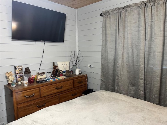 bedroom with wooden walls and wooden ceiling