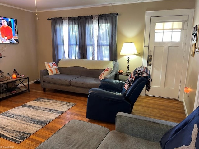 living room with wood-type flooring and ornamental molding