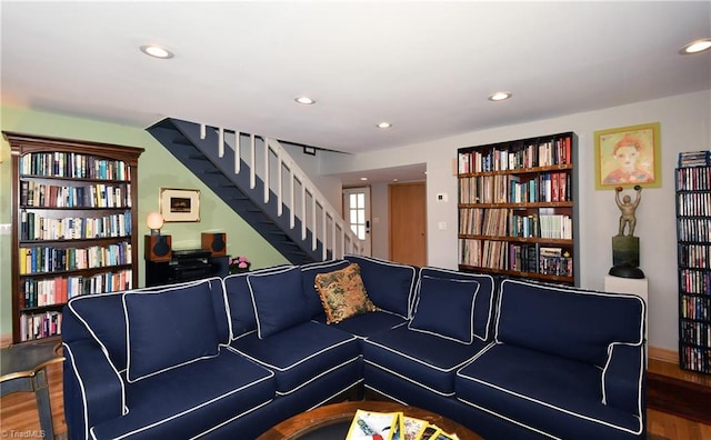 living area featuring stairs, recessed lighting, wood finished floors, and built in features