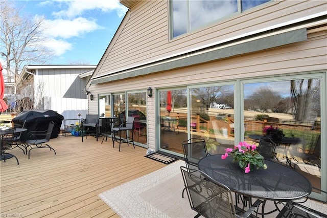 wooden deck featuring outdoor dining area and grilling area