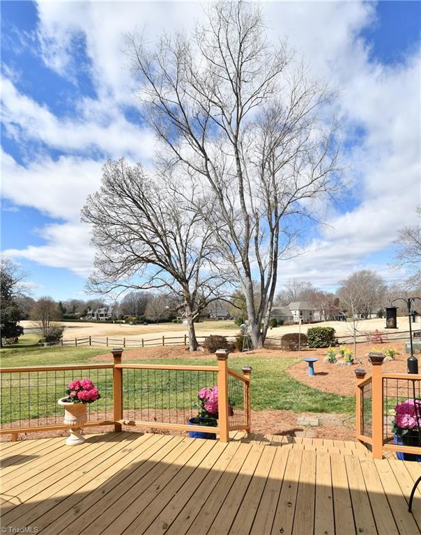 wooden terrace with a lawn