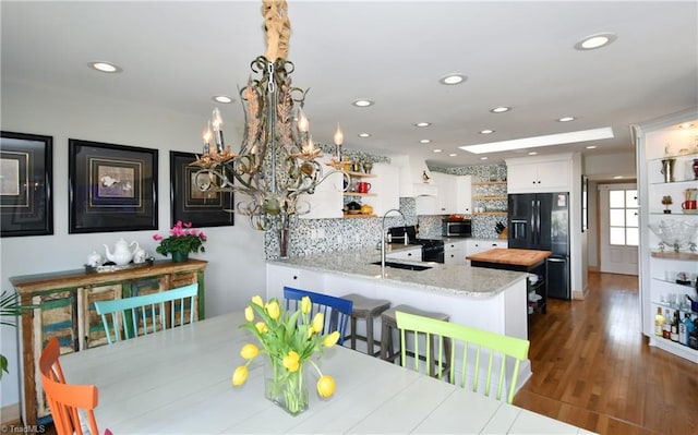 dining area with dark wood finished floors and recessed lighting