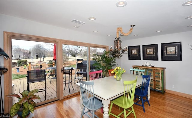 dining area featuring visible vents, baseboards, recessed lighting, wood finished floors, and a notable chandelier