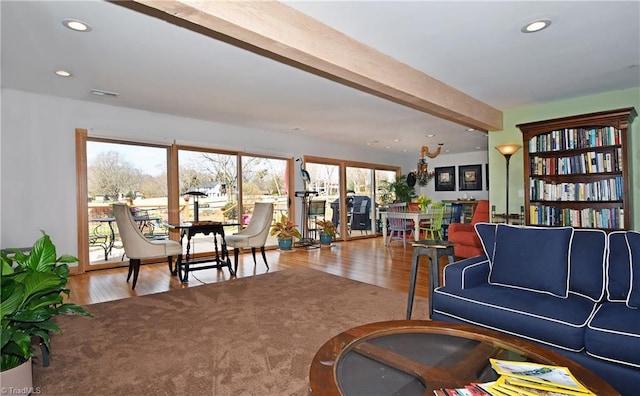 living room featuring beam ceiling, recessed lighting, and wood finished floors