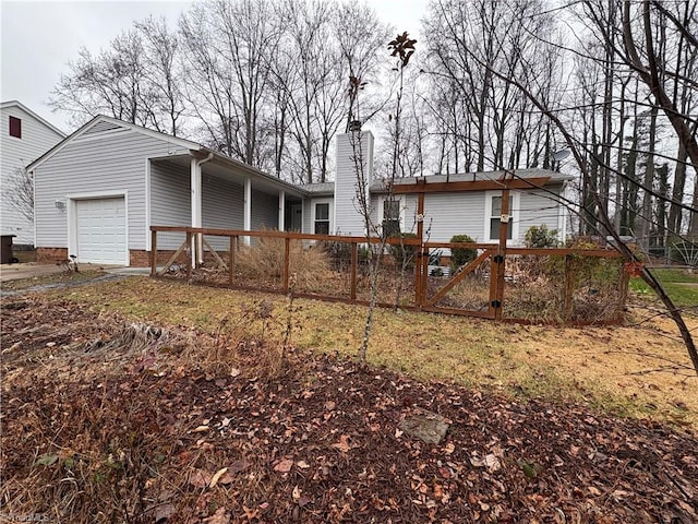 back of property featuring a garage