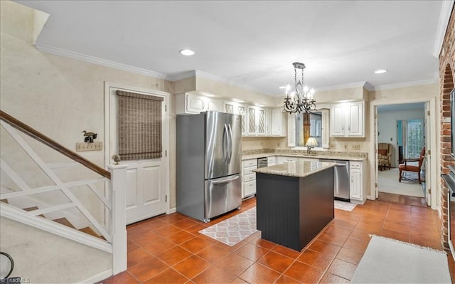 kitchen featuring a kitchen island, white cabinets, decorative light fixtures, and stainless steel appliances