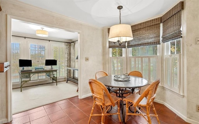 carpeted dining room featuring ornamental molding