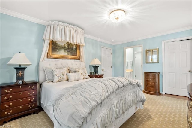 bedroom with ornamental molding and ensuite bath