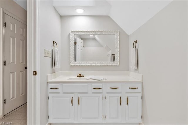 bathroom with vanity and lofted ceiling