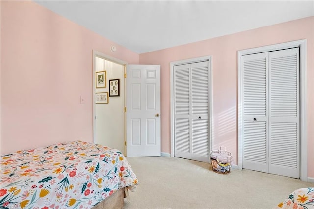 carpeted bedroom with multiple closets