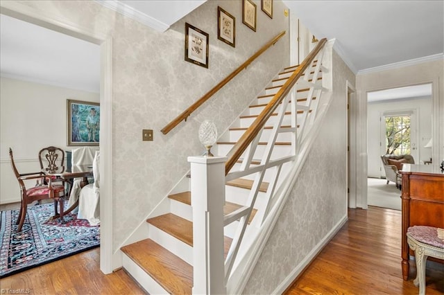 stairway featuring hardwood / wood-style flooring and ornamental molding