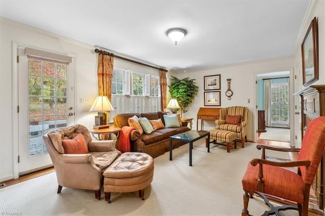 sitting room featuring light colored carpet and crown molding