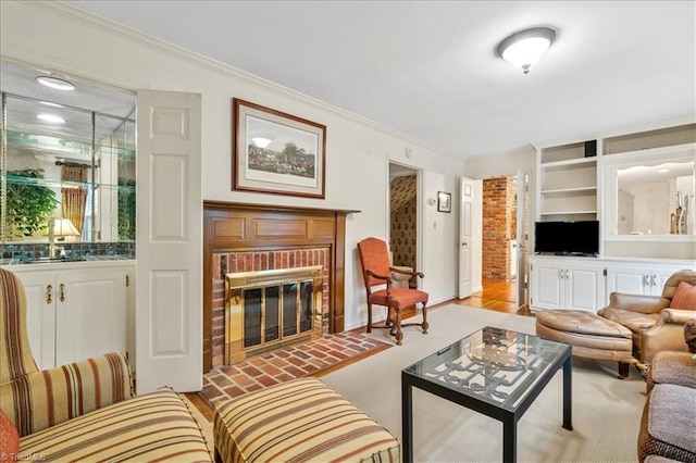 carpeted living room with a brick fireplace, built in shelves, and ornamental molding