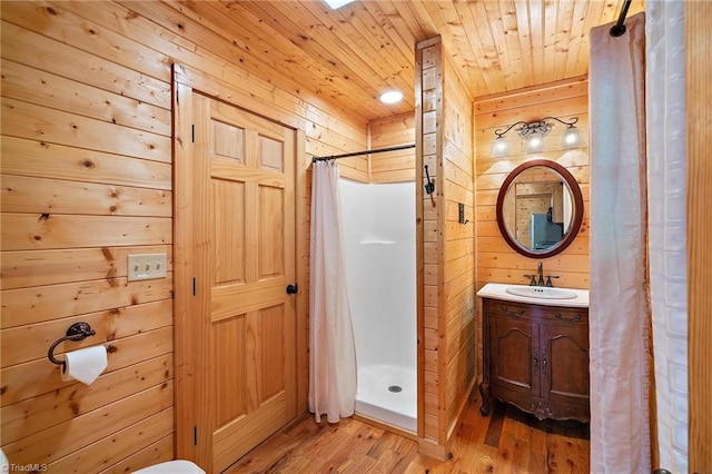 bathroom with wooden walls, wood ceiling, and walk in shower