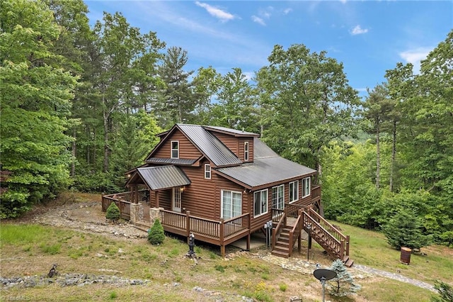 back of property with a wooden deck