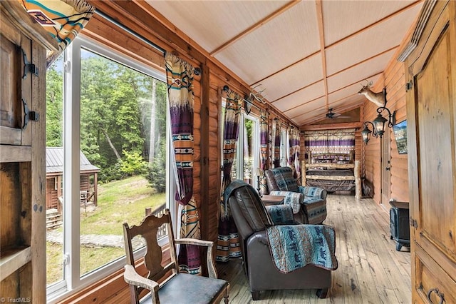 sunroom featuring plenty of natural light, ceiling fan, and lofted ceiling