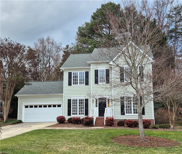 colonial home with a front yard and a garage