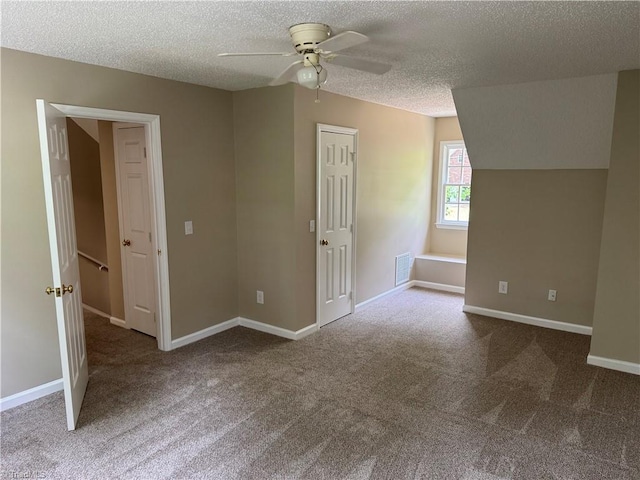 bonus room featuring a ceiling fan, a textured ceiling, and carpet flooring