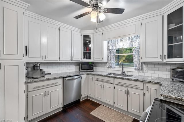 kitchen featuring light stone countertops, sink, white cabinetry, stainless steel appliances, and dark hardwood / wood-style floors