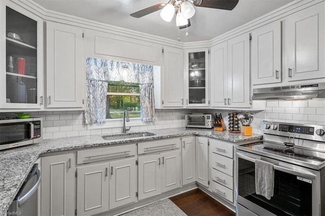 kitchen with white cabinetry, light stone countertops, appliances with stainless steel finishes, and sink