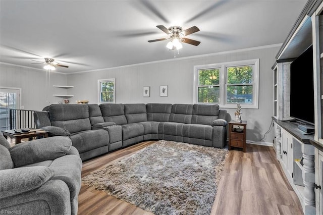 living room with ornamental molding, a healthy amount of sunlight, and hardwood / wood-style flooring