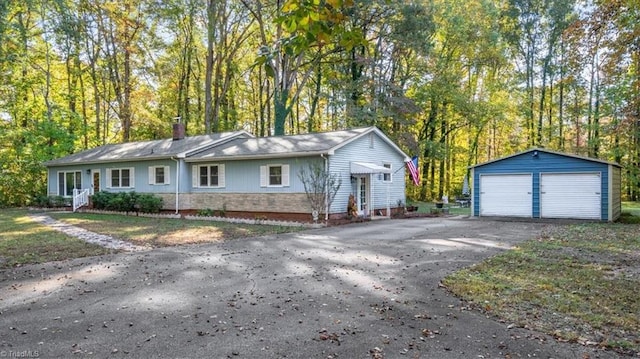 view of front of property featuring an outdoor structure and a garage