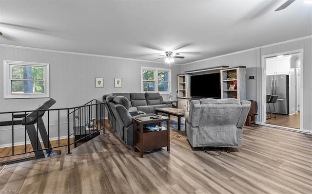 living room featuring ornamental molding, hardwood / wood-style flooring, and ceiling fan