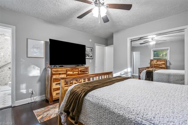 bedroom featuring dark hardwood / wood-style floors, ensuite bath, a textured ceiling, and ceiling fan