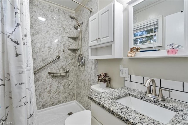 bathroom featuring vanity, toilet, and curtained shower