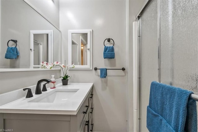 bathroom featuring vanity and an enclosed shower