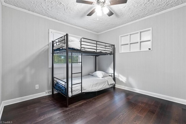 unfurnished bedroom featuring crown molding, dark hardwood / wood-style floors, and ceiling fan