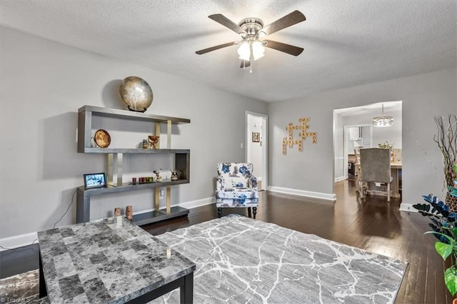 bedroom featuring ceiling fan, a textured ceiling, and dark hardwood / wood-style floors