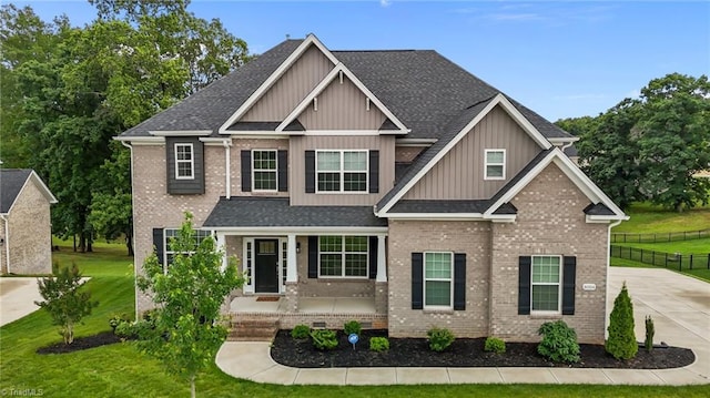 8004 Hacker Dr, Stokesdale, NC 27357 - craftsman inspired home with board and batten siding, brick siding, roof with shingles, driveway, and a porch