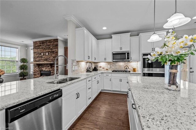 8004 Hacker Dr, Stokesdale, NC 27357 - kitchen with appliances with stainless steel finishes, a sink, crown molding, light stone counters, and white cabinetry