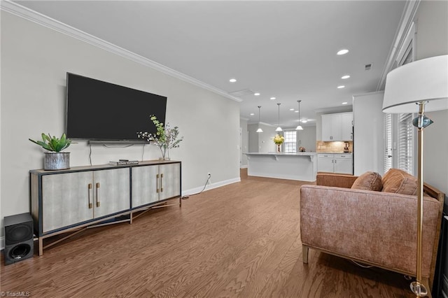 8004 Hacker Dr, Stokesdale, NC 27357 - living room featuring wood finished floors, recessed lighting, ornamental molding, and baseboards