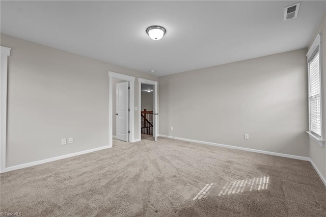 8004 Hacker Dr, Stokesdale, NC 27357 - unfurnished bedroom featuring carpet, multiple windows, and baseboards