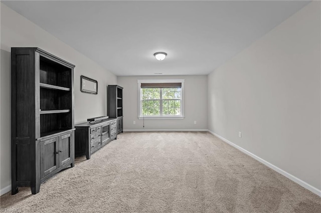 8004 Hacker Dr, Stokesdale, NC 27357 - unfurnished living room featuring baseboards and light carpet