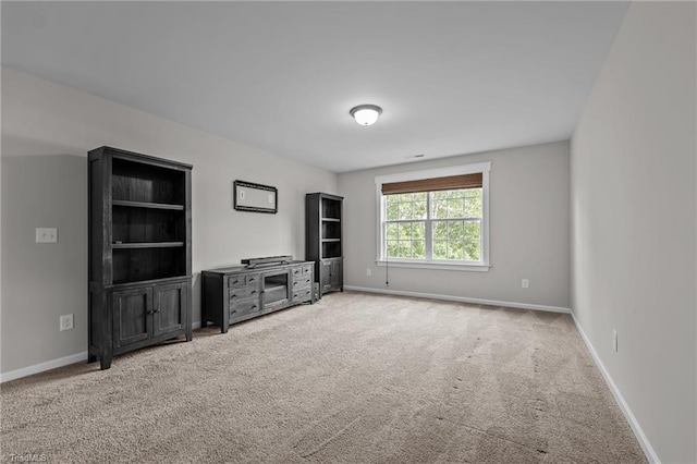 8004 Hacker Dr, Stokesdale, NC 27357 - unfurnished living room with carpet flooring and baseboards