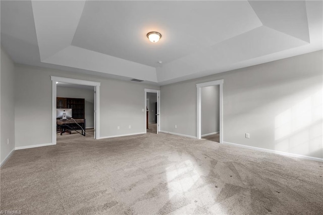 8004 Hacker Dr, Stokesdale, NC 27357 - unfurnished living room featuring a raised ceiling, carpet flooring, baseboards, and an office area