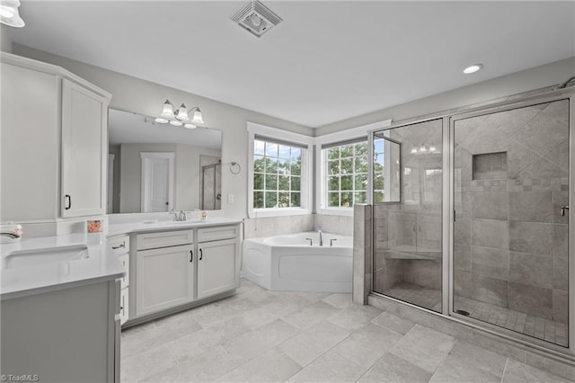 8004 Hacker Dr, Stokesdale, NC 27357 - bathroom featuring vanity, a garden tub, a stall shower, and recessed lighting