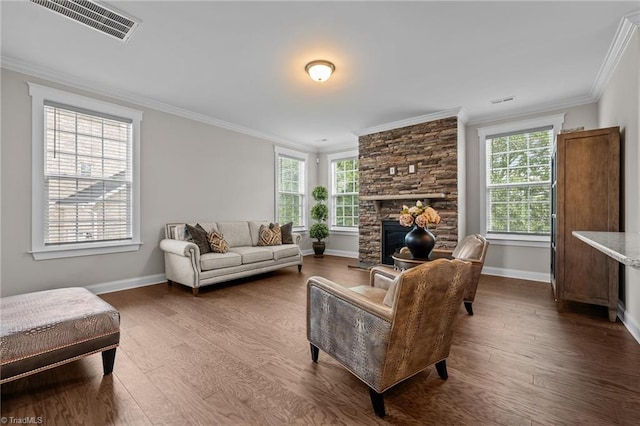 8004 Hacker Dr, Stokesdale, NC 27357 - living area with crown molding, wood finished floors, baseboards, and a stone fireplace