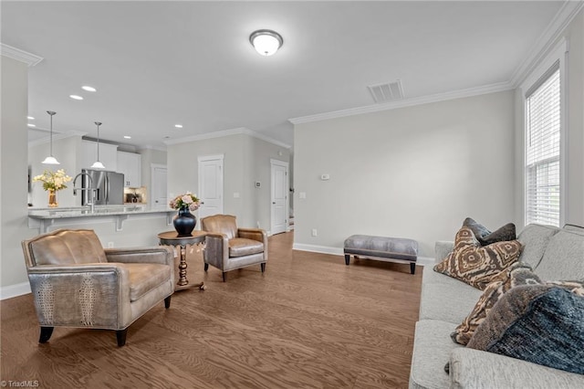 8004 Hacker Dr, Stokesdale, NC 27357 - living area with wood finished floors, baseboards, crown molding, and recessed lighting