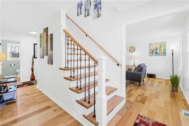 staircase with hardwood / wood-style floors