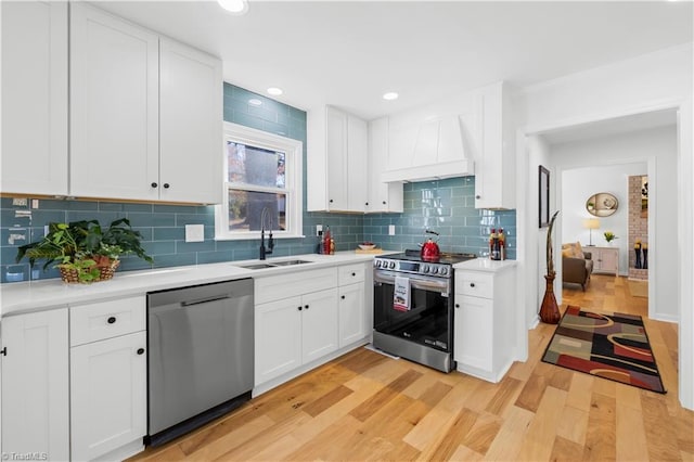 kitchen featuring sink, white cabinetry, and appliances with stainless steel finishes