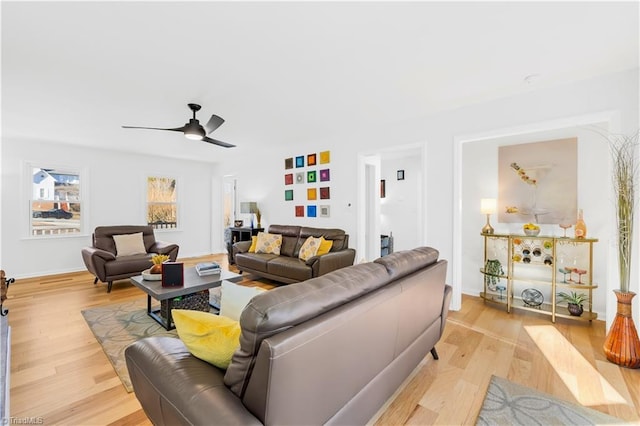 living room with ceiling fan and light hardwood / wood-style flooring