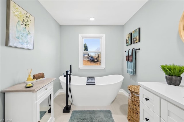 bathroom featuring a bathtub, tile patterned floors, and vanity