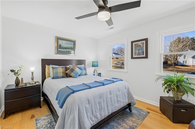 bedroom with ceiling fan and light hardwood / wood-style flooring